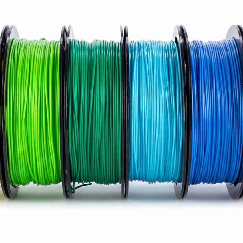 colorful bright wide panorama row of spool 3d printer pla abs filament plastic material isolated on white background