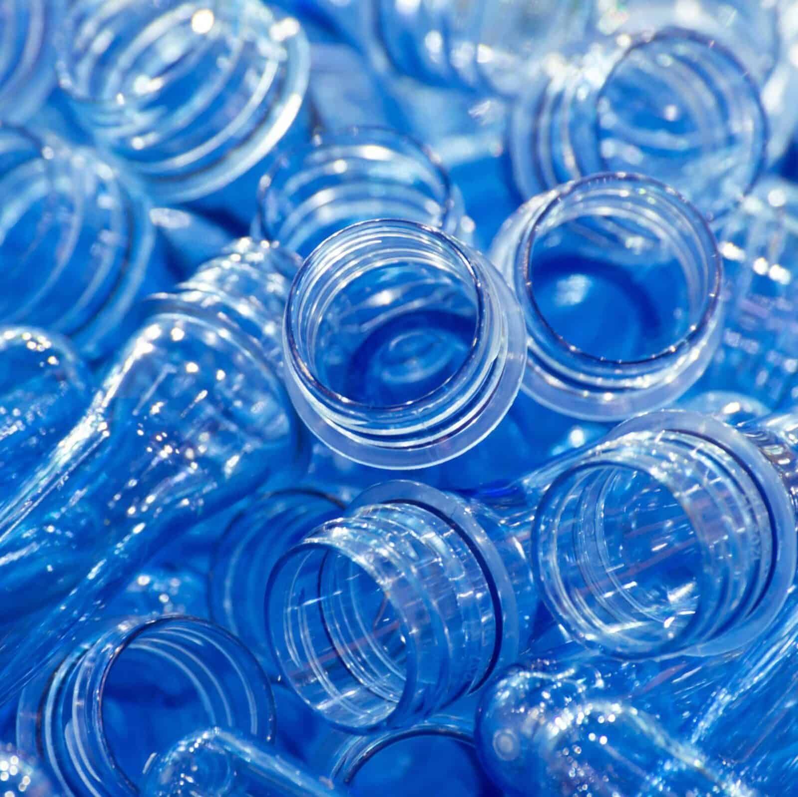 blue plastic PET bottles in a heap ready for recycling